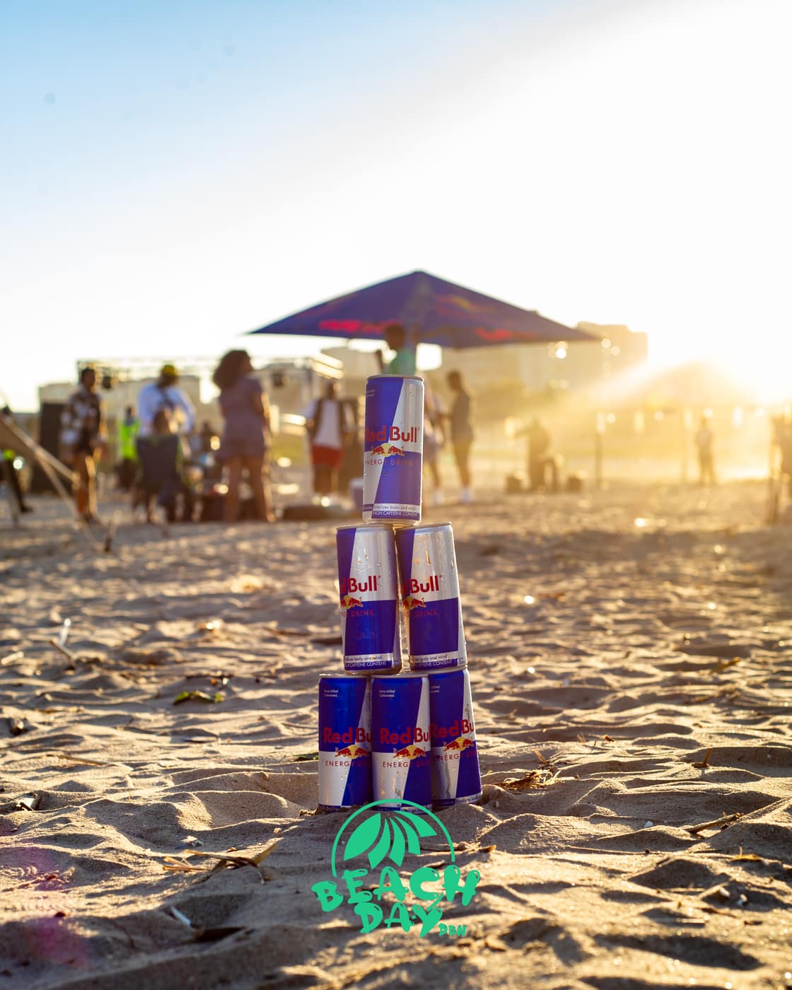 Golden-hour crowd on the sand as the party warms up