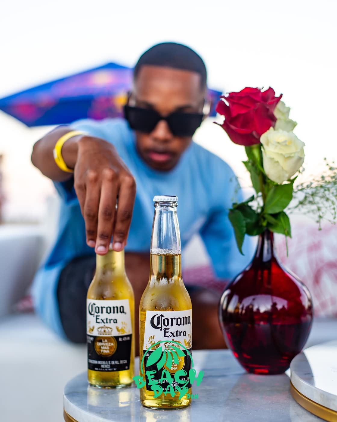 A guest reaching for an ice-cold Corona at golden hour