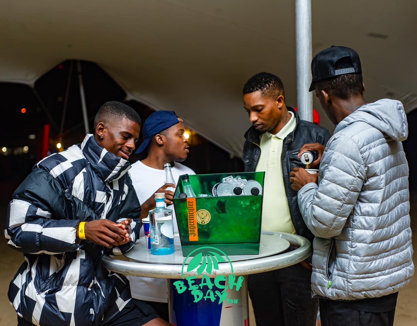 Friends gathered around a table with drinks at night